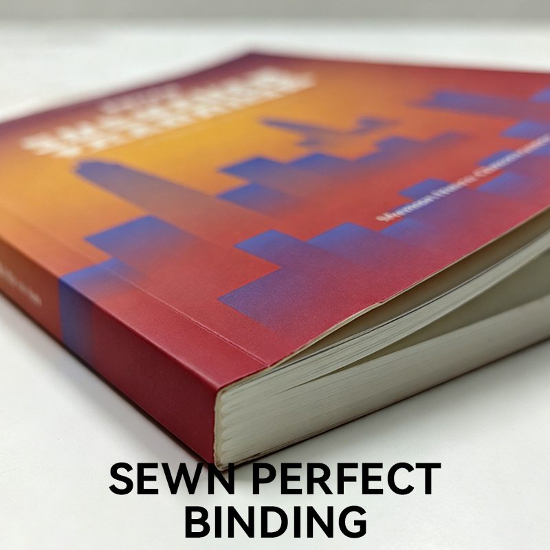 Close-up of a sewn perfect bound book showing the durable threaded spine and vibrant printed cover.