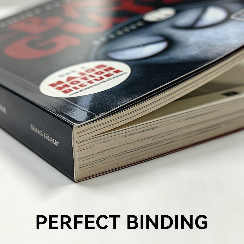 Detail of a standard perfect bound paperback book displaying a flat, glued square spine and crisp edges.